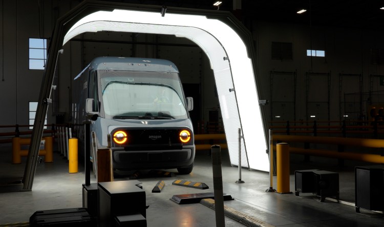 Amazon Rivian electric devliery van being inspected by UVeye scanner.