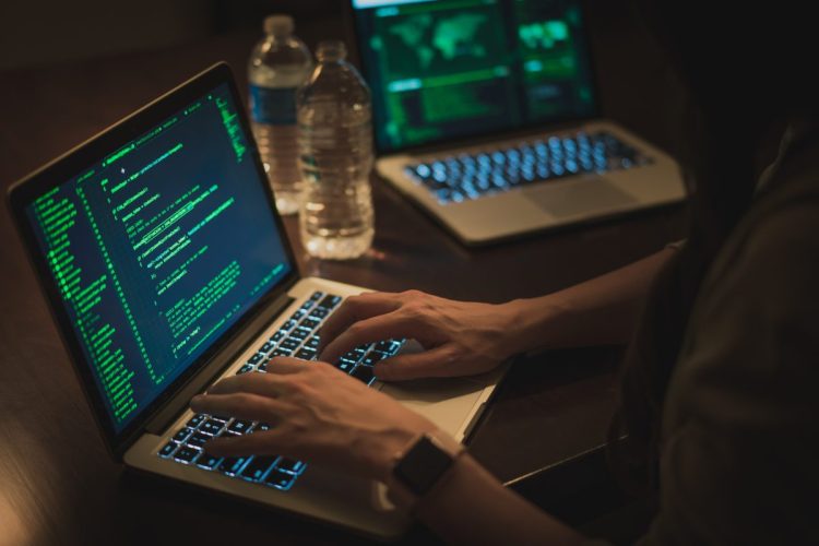 Picture of a person's hands on a laptop keyboard, representing coding, software development, programmer